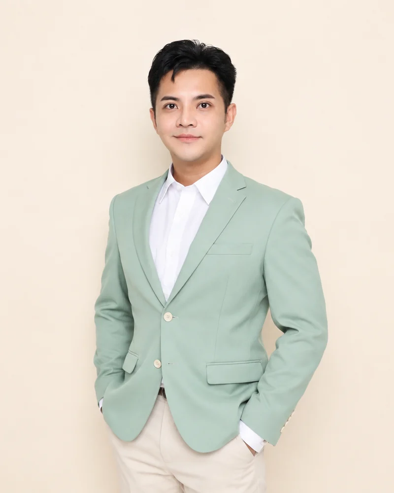 Suebsakul “Aaron” Tonjang, Co-Founder and CEO of DekNurse, in a sage green blazer